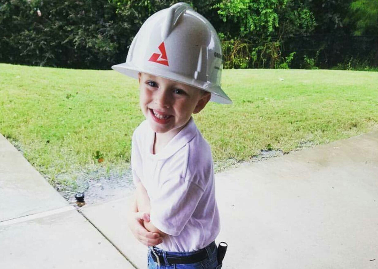 Young Boy Wearing a Georgia Power Helmet